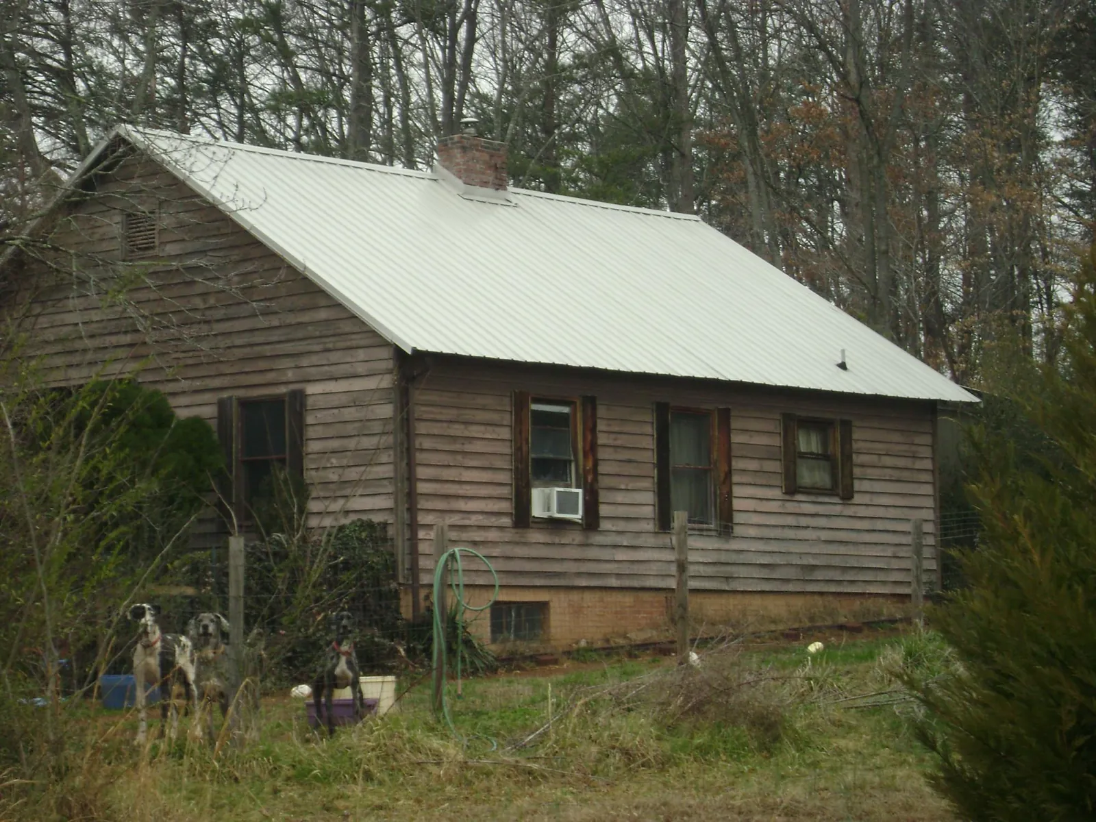 White metal roof on an old wood sided farmhouse, from a Metal Roof Installation job in Aubrey